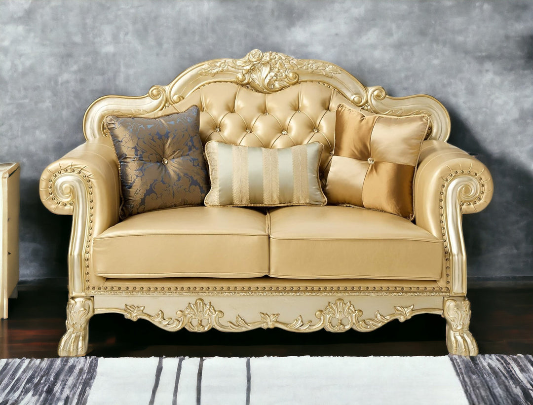 64" Bone And Gold Faux Leather Loveseat and Toss Pillows